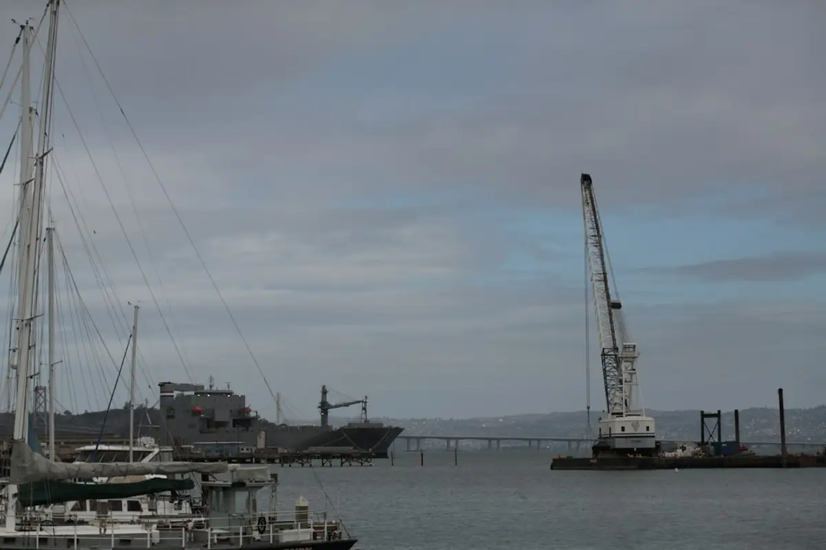 Marine contractor crew placing 4-Ton Texas Tuff Rock Bags by excavator on a bulkhead, hi-vis PPE visible