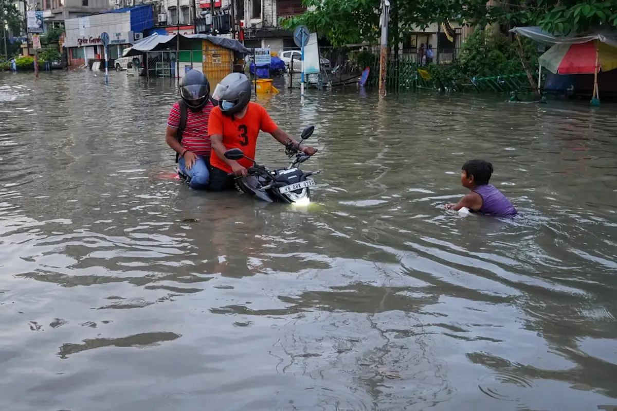 Floodwater scene with rock bags being deployed for emergency repair