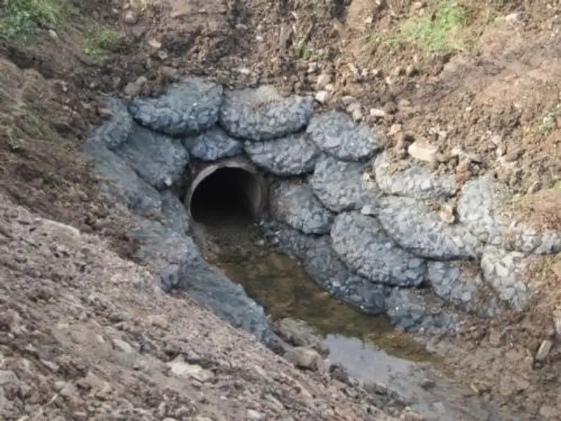Rock bags protecting a culvert outfall from scour — photo 2