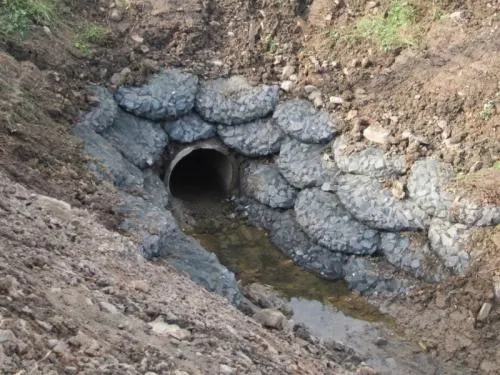 Rock bags protecting a culvert outfall from scour — photo 2